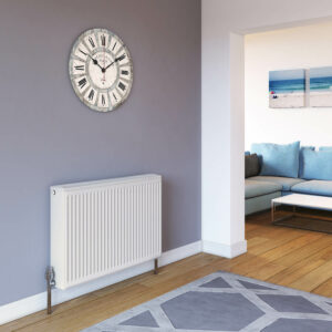 Stelrad Softline Compact K3 against a purple wall in a living room