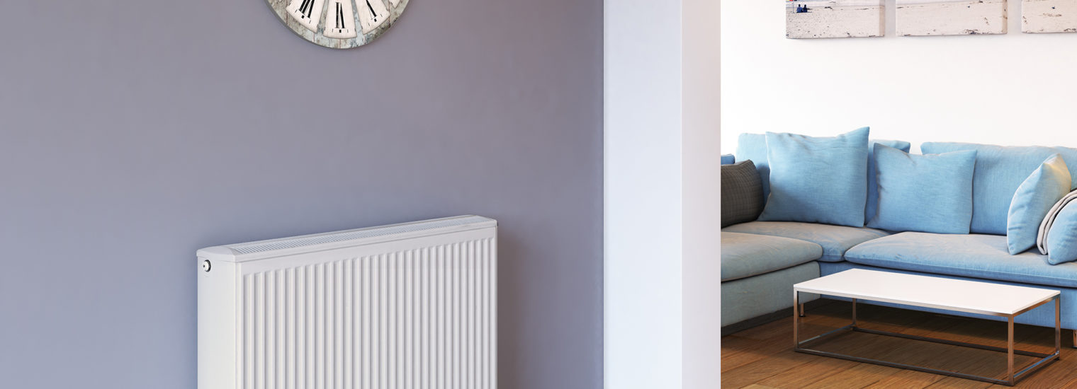 Stelrad Softline Compact K3 against a purple wall in a living room