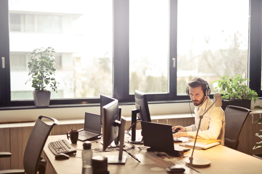 Man working in office with headset on