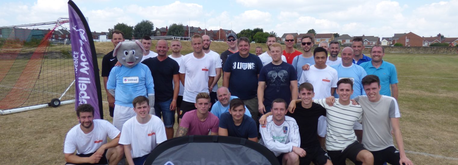 Both teams in the charity match pose for the camera