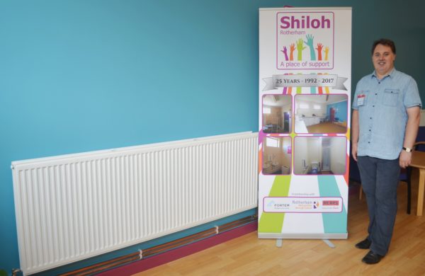 Shiloh Centre Manager Kevin Quinton with one of the new radiators in the dining room at Shiloh