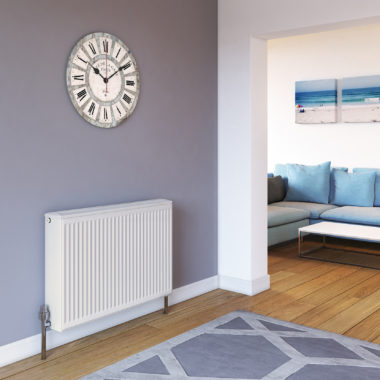 Stelrad Softline Compact K3 against a purple wall in a living room