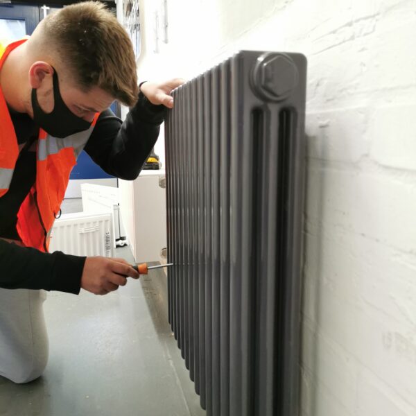 Stelrad employee installing radiator for local college