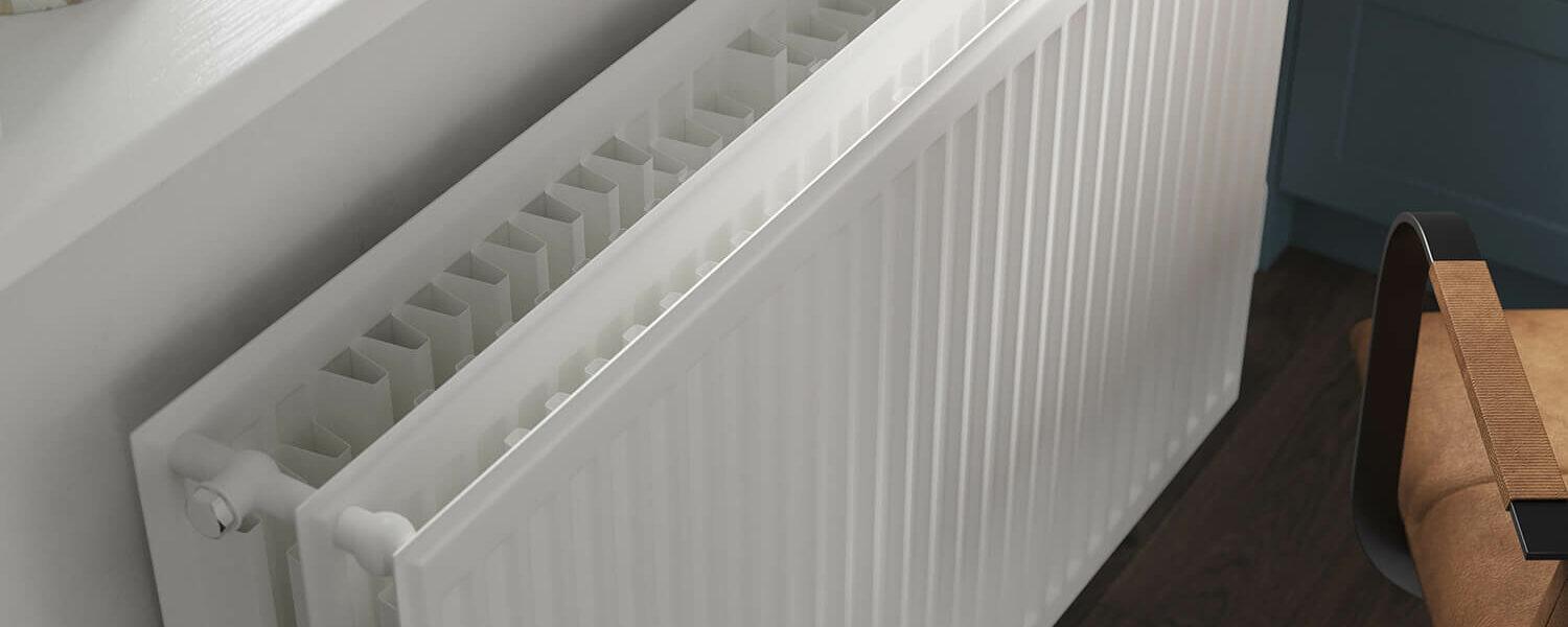 Stelrad K3 radiator positioned against a grey wall in an home office room