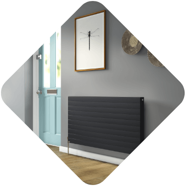 Black column radiator in grey room with dragon fly painting above