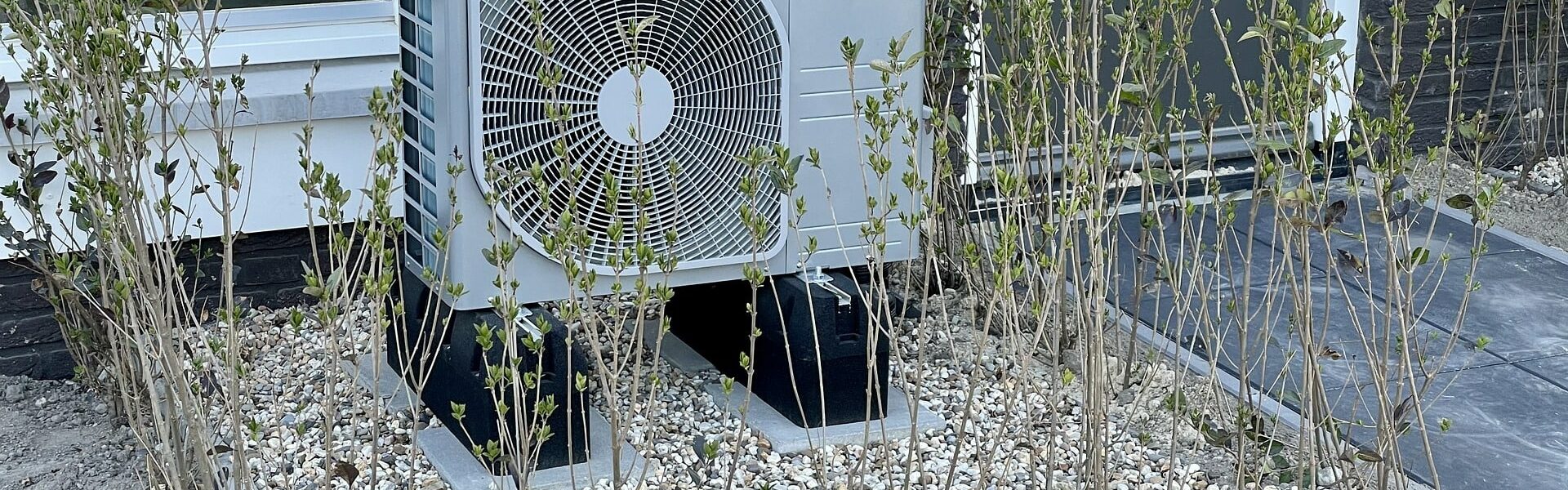 an air source heat pump outside a house