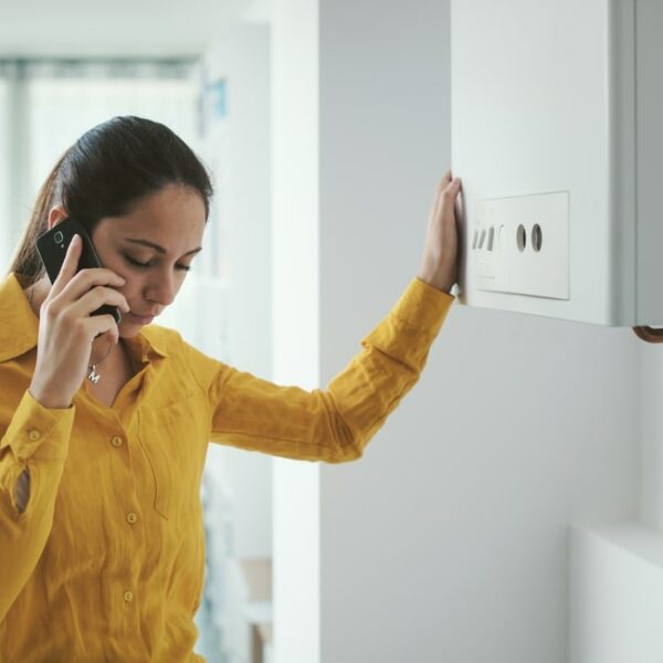 woman with a broken boiler phoning for help