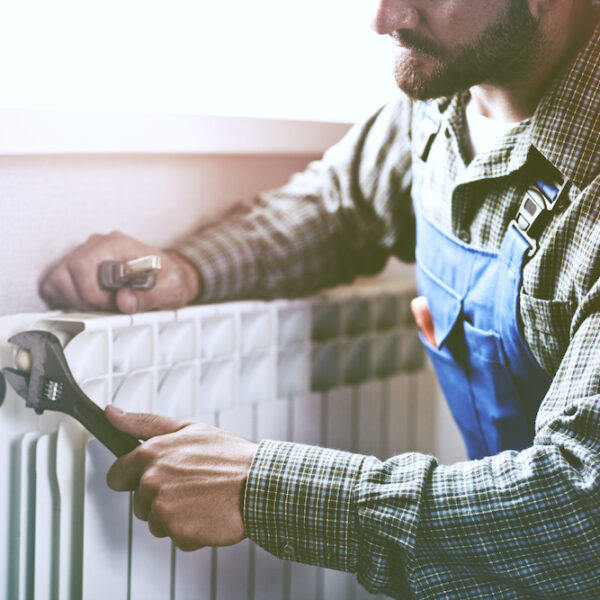 A man fixing a radiator.
