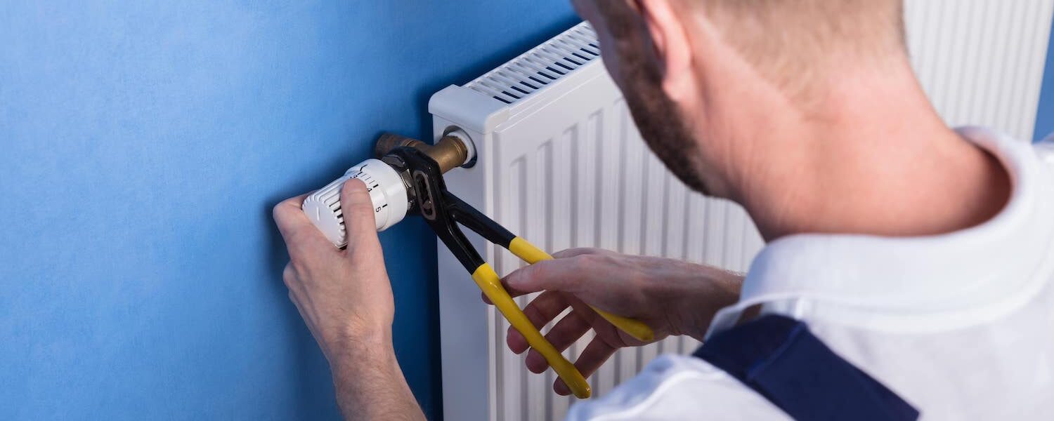 Man fixing radiator